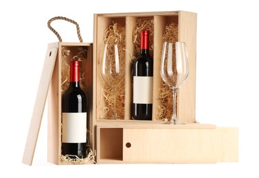 Photo of Wooden gift boxes with wine and glasses isolated on white