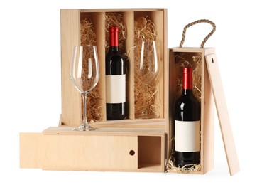 Photo of Wooden gift boxes with wine and glasses isolated on white