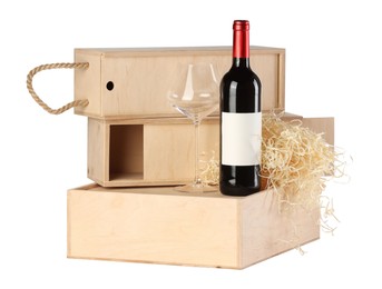 Photo of Wooden gift boxes with wine and glass isolated on white