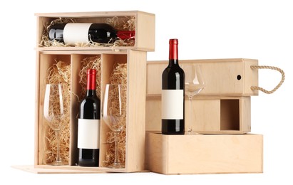 Wooden gift boxes with wine and glasses isolated on white