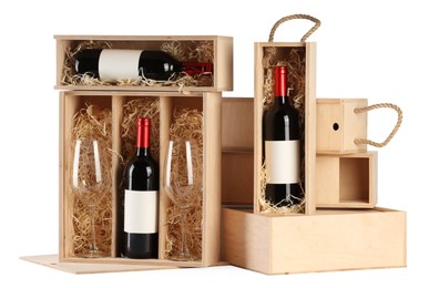 Photo of Wooden gift boxes with wine and glasses isolated on white