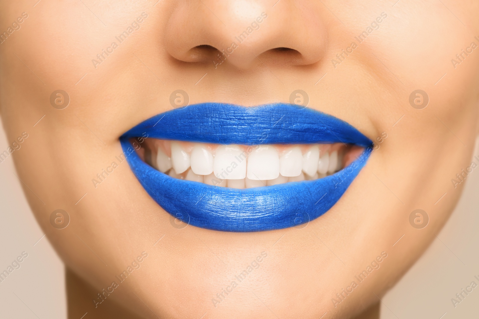 Photo of Smiling woman with healthy teeth on light background, closeup view