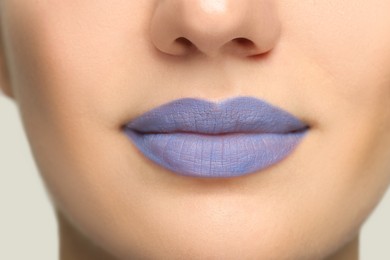 Photo of Woman wearing blue lipstick on light background, closeup view