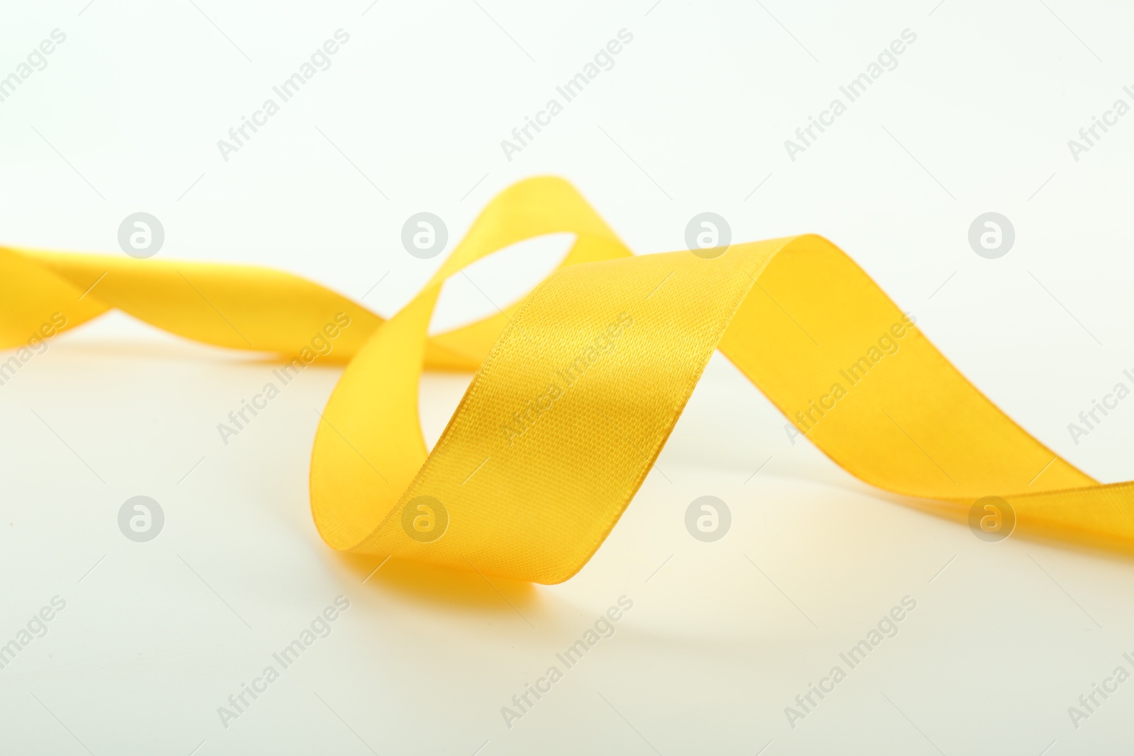 Photo of One beautiful yellow ribbon isolated on white