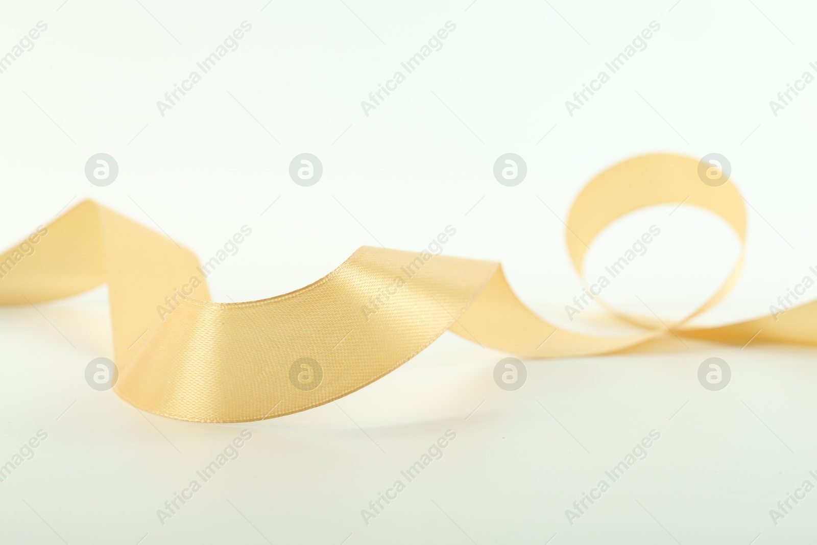 Photo of One beautiful light yellow ribbon isolated on white