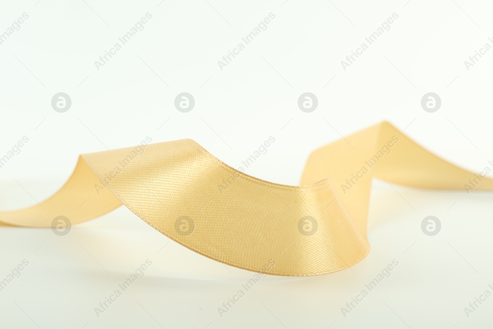 Photo of One beautiful light yellow ribbon isolated on white