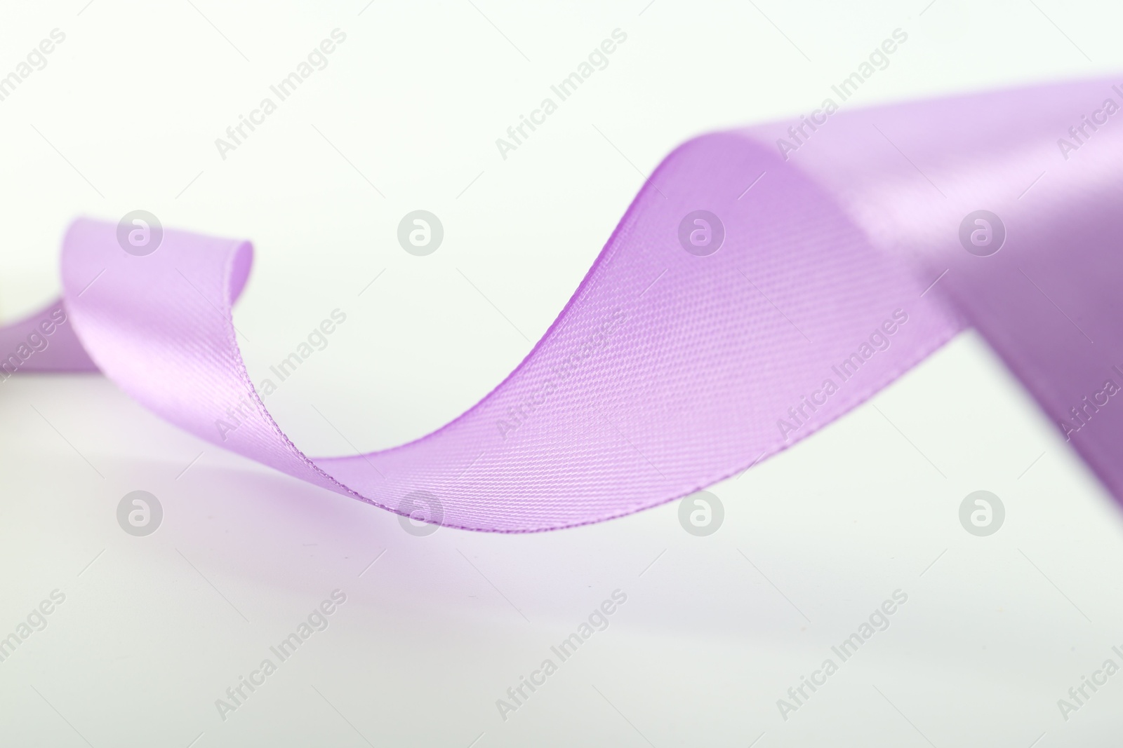 Photo of One beautiful violet ribbon isolated on white