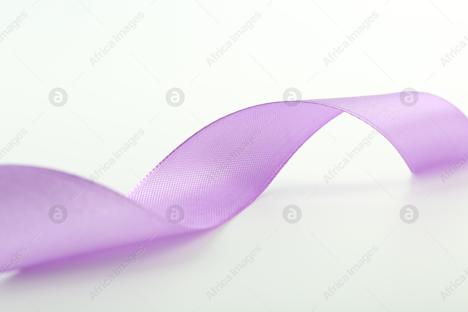 Photo of One beautiful violet ribbon isolated on white