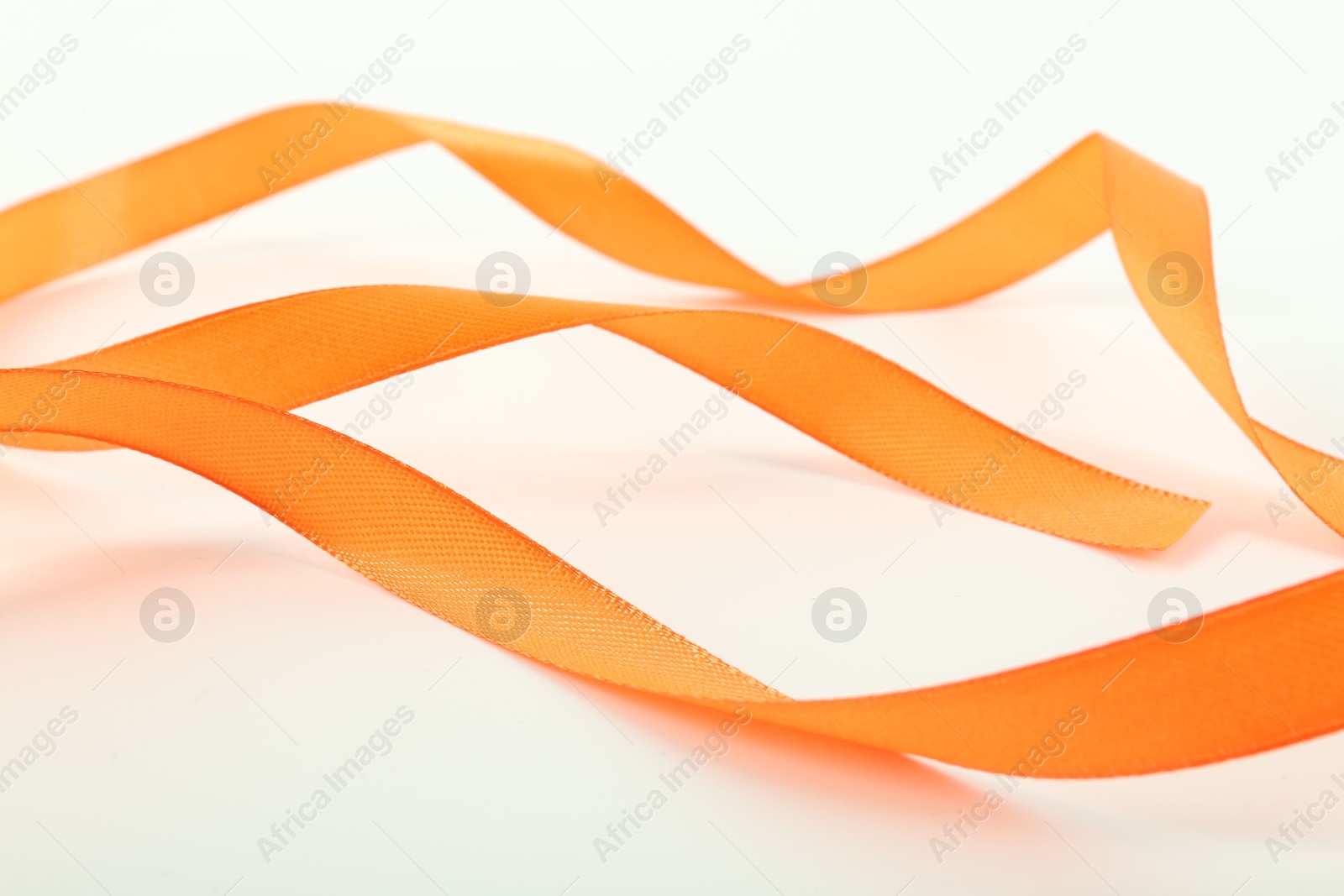 Photo of One beautiful orange ribbon isolated on white