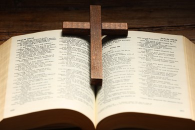 Bible and cross on table, closeup. Religion of Christianity