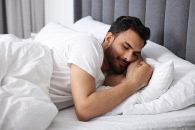 Handsome man sleeping in bed at morning