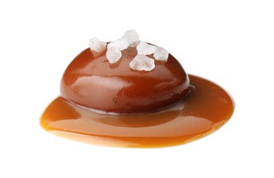 Photo of Tasty candy, caramel sauce and salt isolated on white