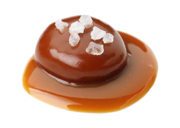 Photo of Tasty candy, caramel sauce and salt isolated on white