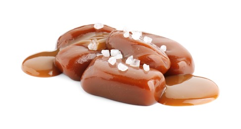 Tasty candies, caramel sauce and salt isolated on white