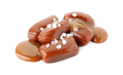 Photo of Tasty candies, caramel sauce and salt isolated on white