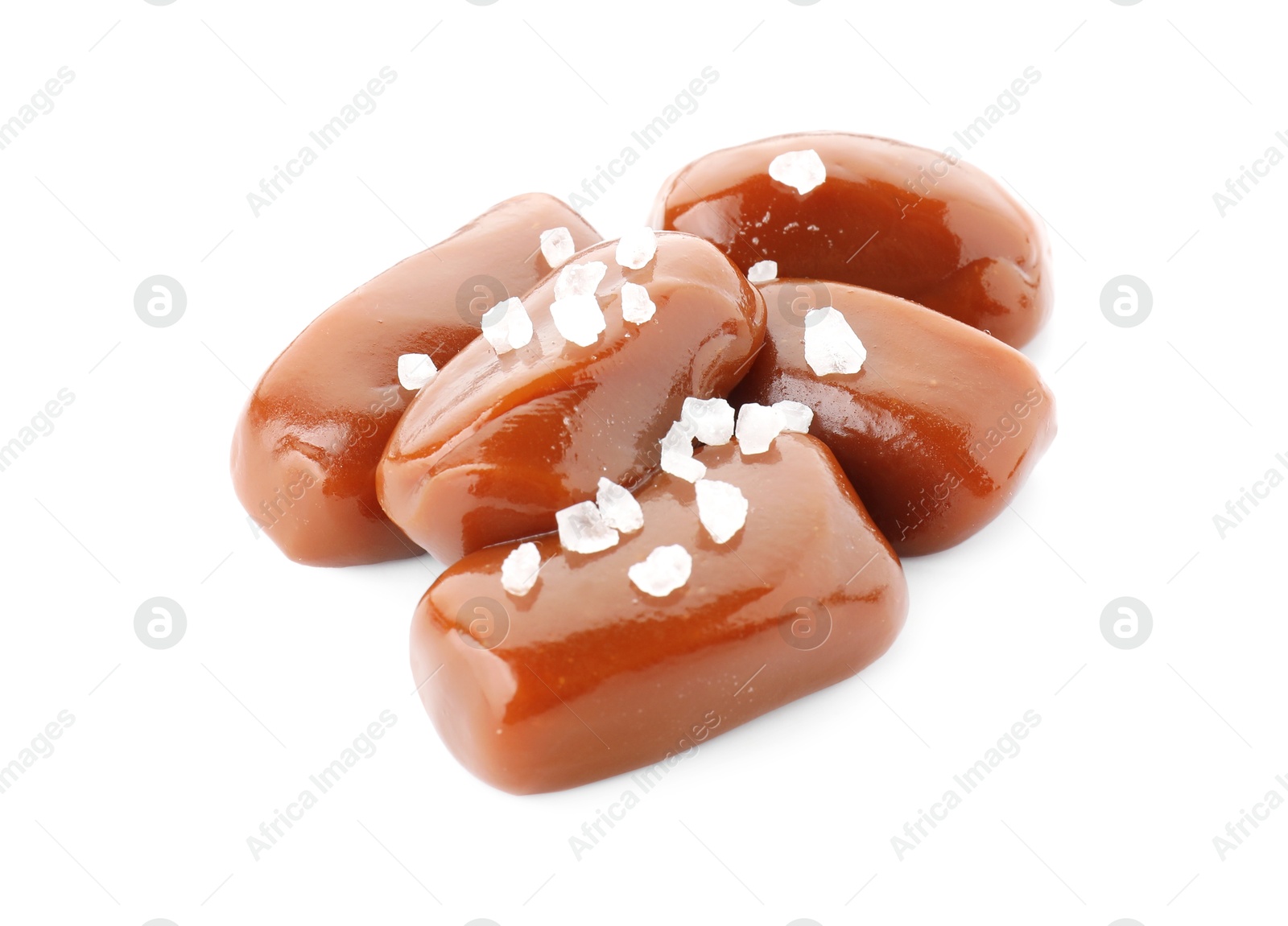 Photo of Tasty caramel candies with salt isolated on white