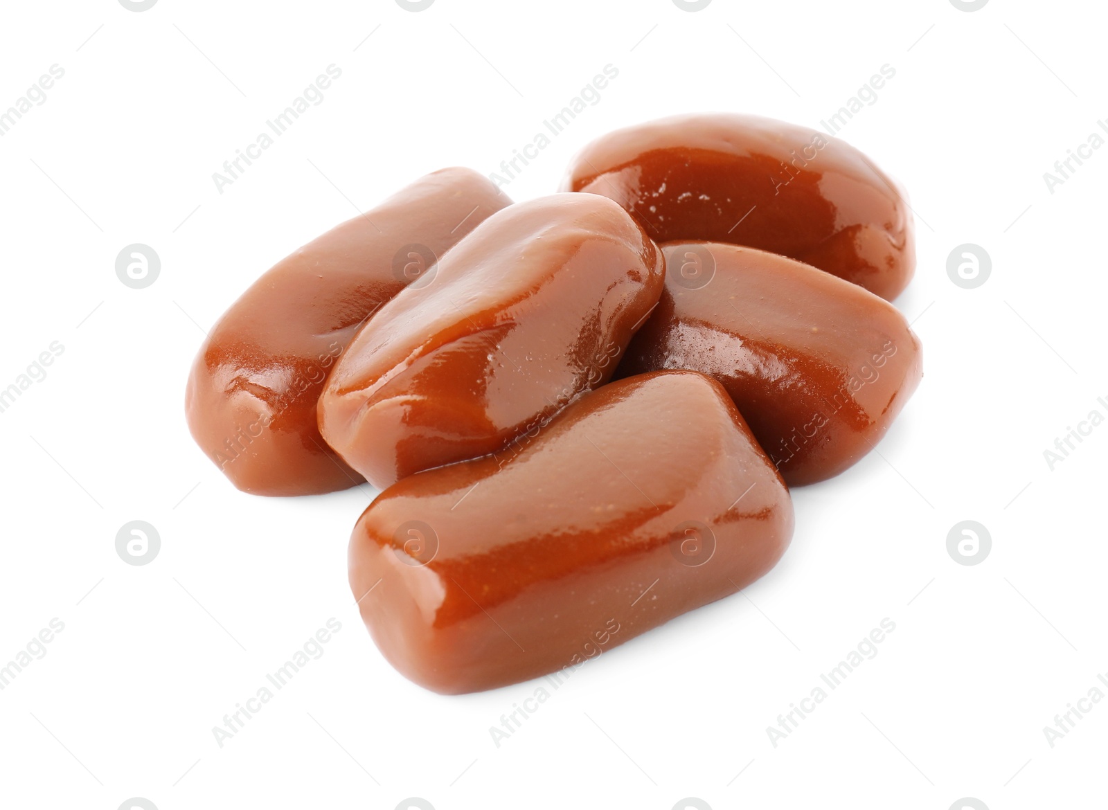 Photo of Tasty sweet caramel candies isolated on white