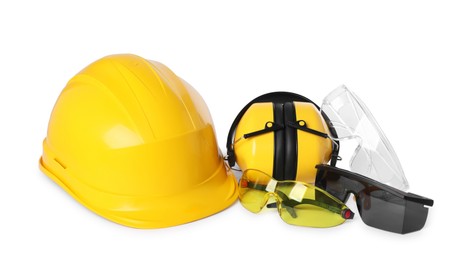 Hard hat, earmuffs and protective goggles isolated on white