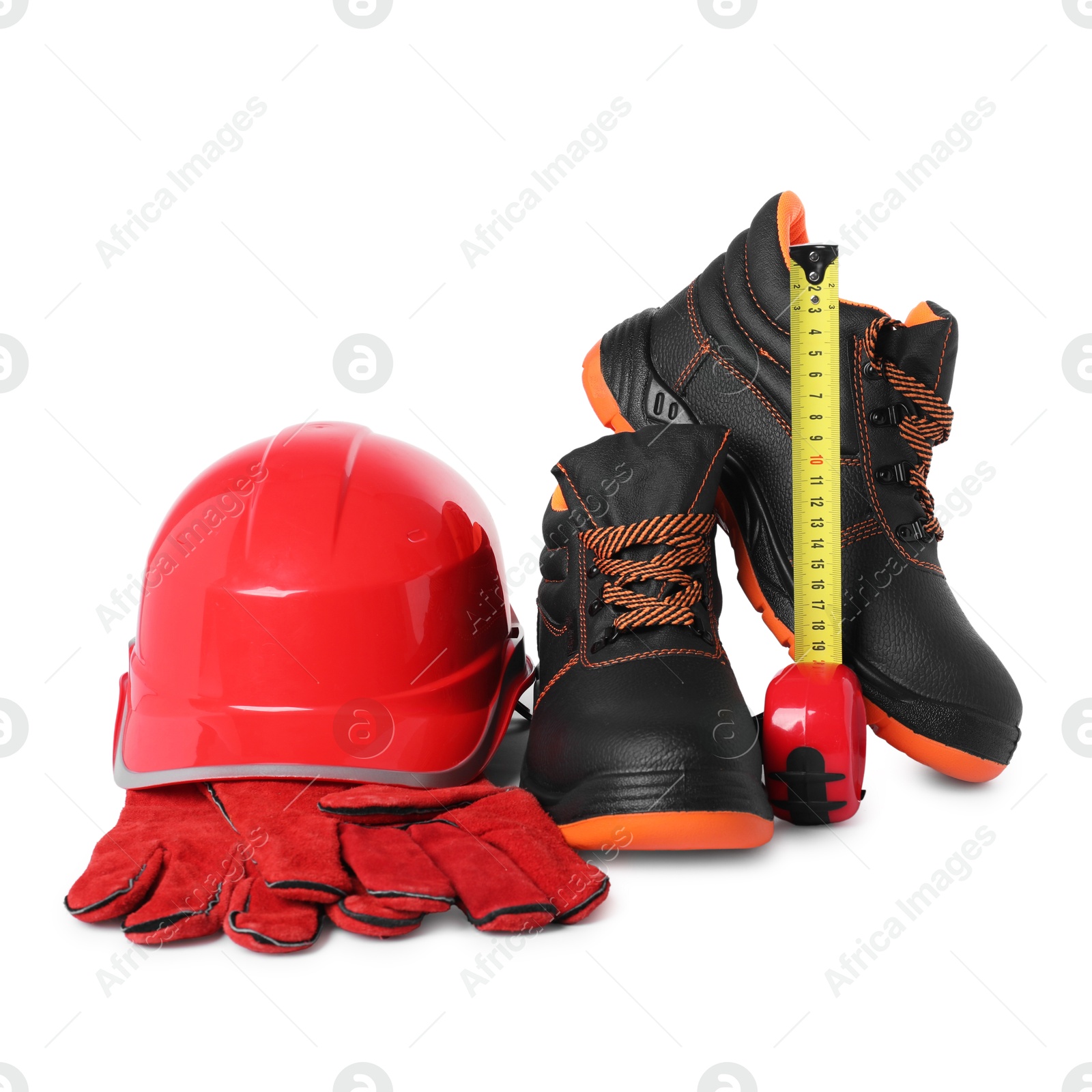 Photo of Pair of working boots, hard hat, tape measure and protective gloves isolated on white