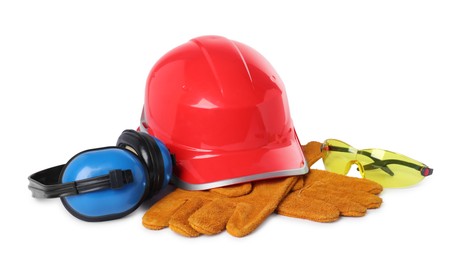 Photo of Hard hat, gloves, earmuffs and protective goggles isolated on white