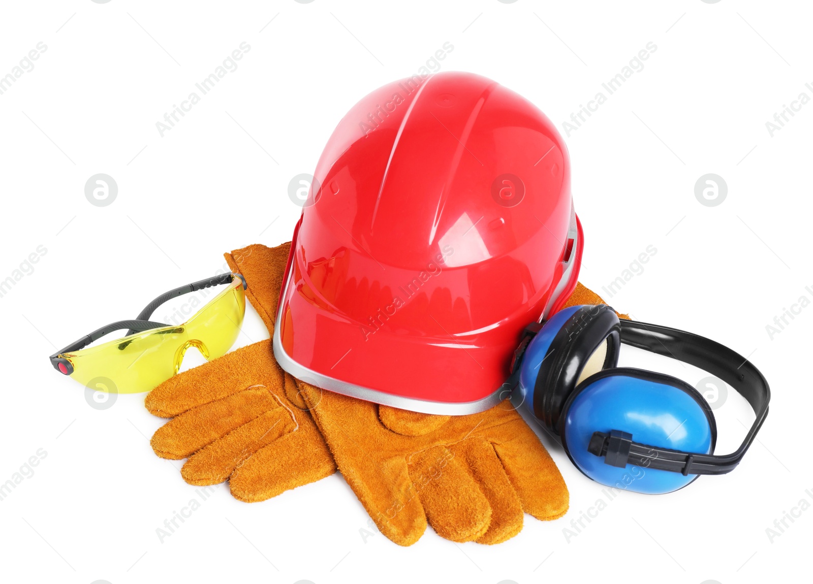 Photo of Hard hat, gloves, earmuffs and protective goggles isolated on white