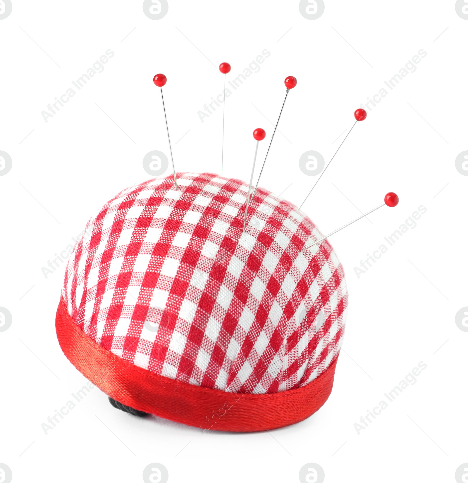 Photo of Red pincushion with sewing pins isolated on white