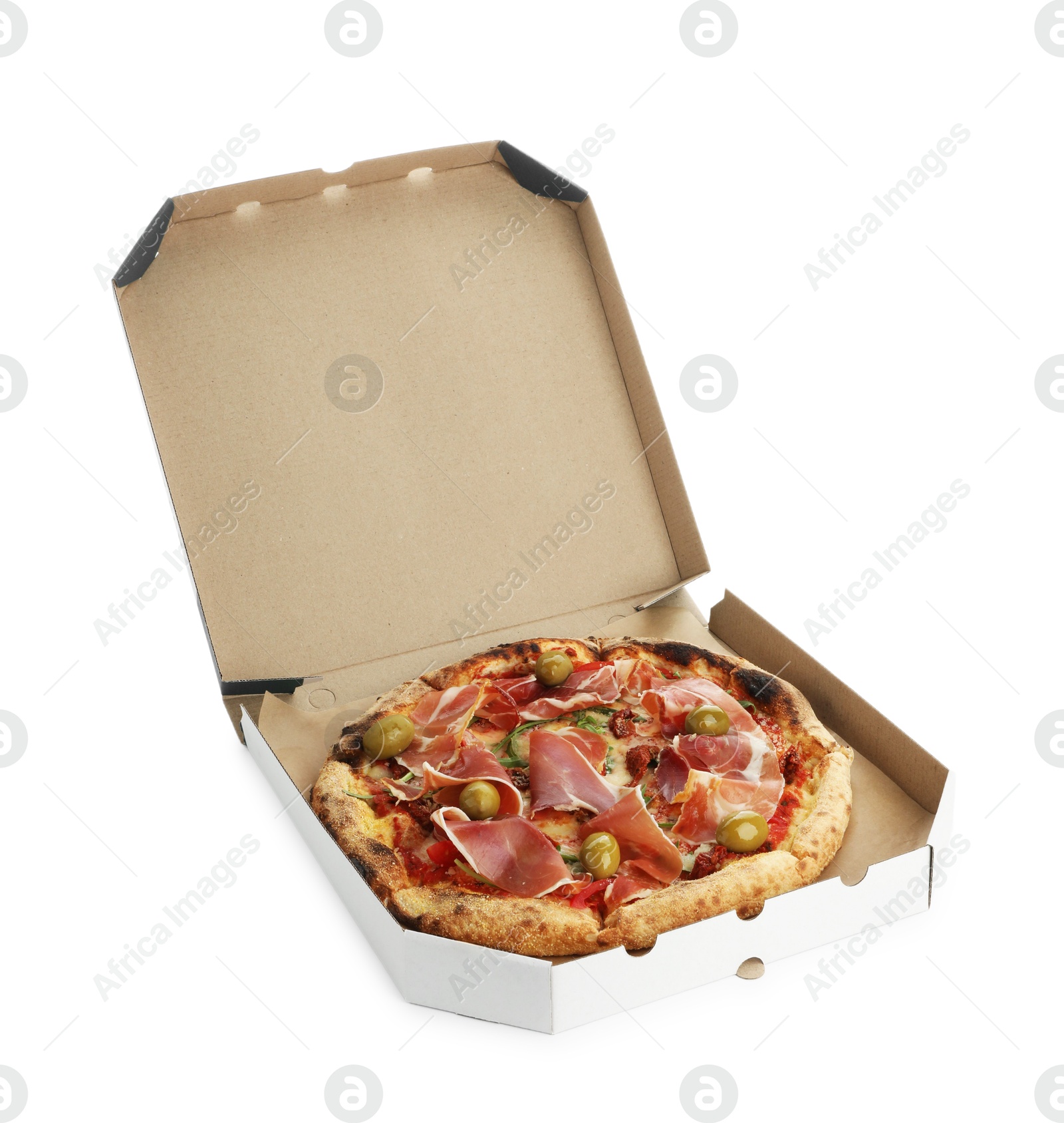 Photo of Tasty pizza with cured ham, olives and sun-dried tomato in cardboard box isolated on white