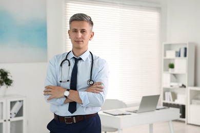Portrait of doctor with stethoscope in clinic, space for text
