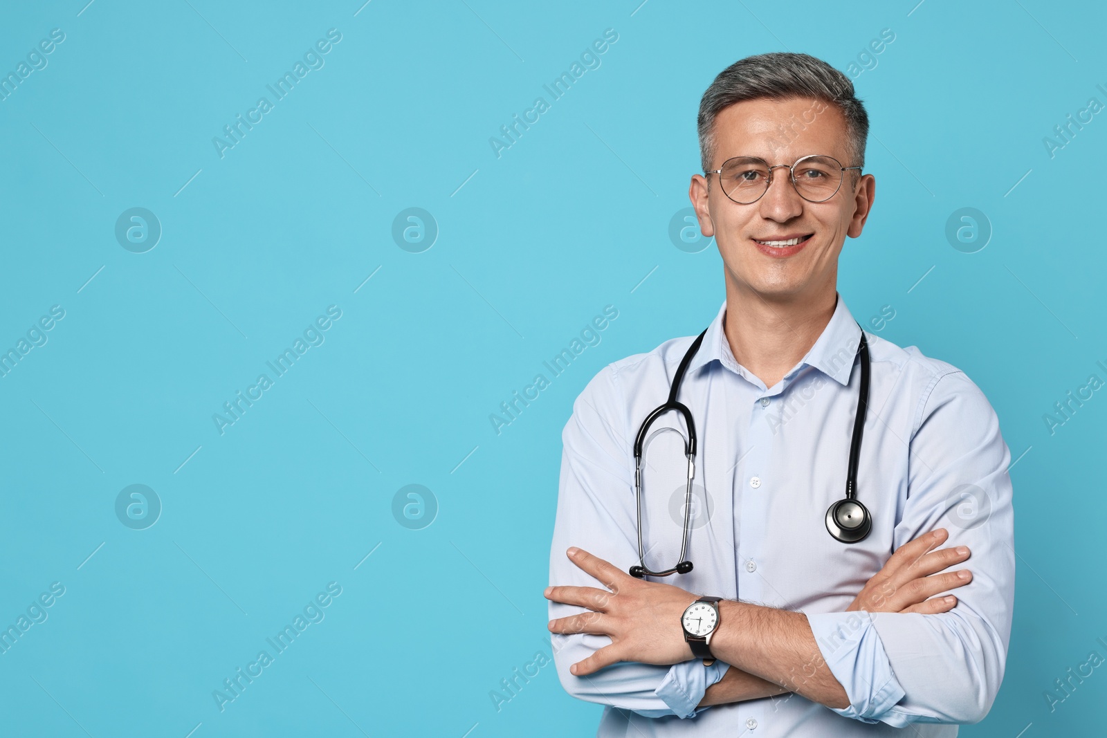 Photo of Doctor with stethoscope on light blue background, space for text