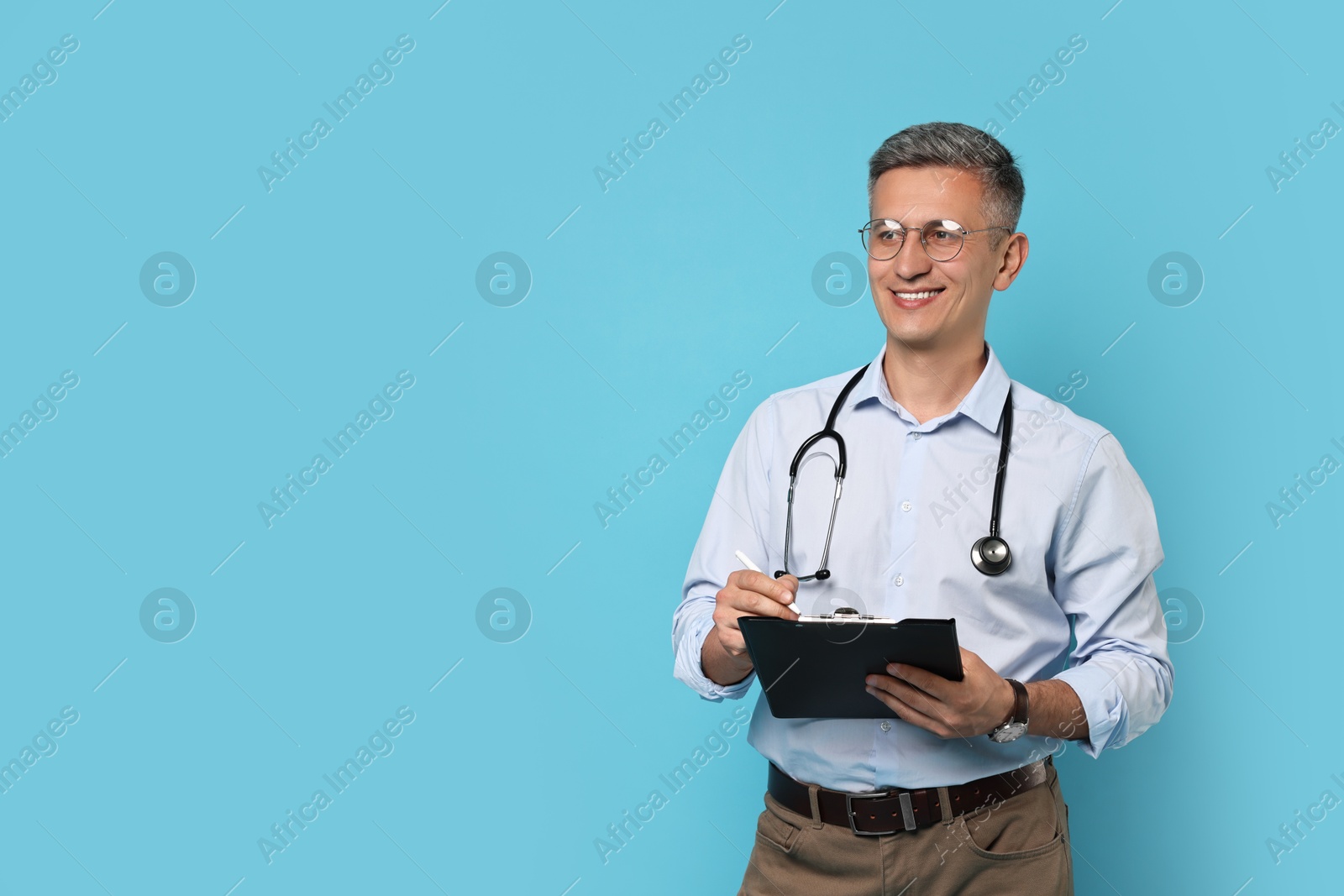 Photo of Doctor with stethoscope and clipboard on light blue background, space for text