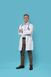 Photo of Doctor with stethoscope on light blue background