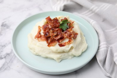 Fried bacon, mashed potato and parsley on white marble table