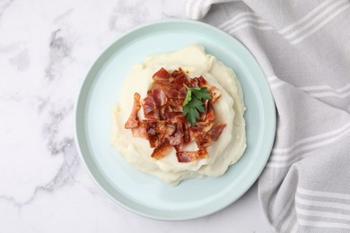 Fried bacon, mashed potato and parsley on white marble table, top view