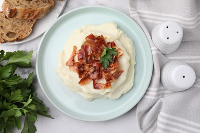 Photo of Fried bacon, mashed potato, parsley and bread on white marble table, top view