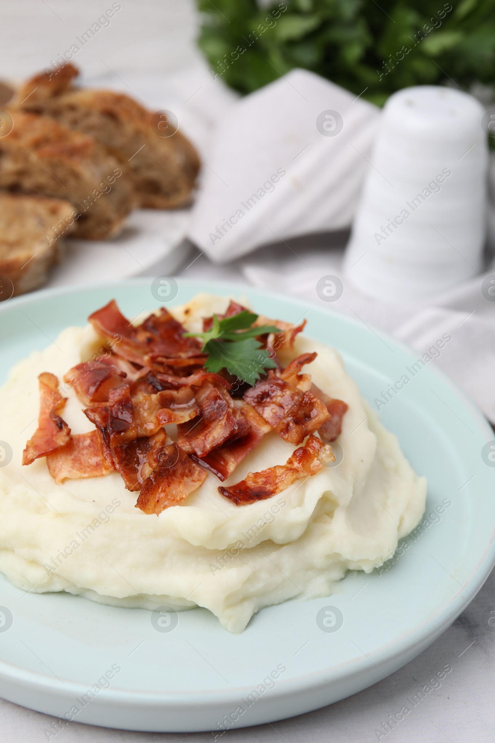 Photo of Fried bacon, mashed potato and parsley on table