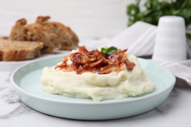 Photo of Fried bacon, mashed potato and parsley on white marble table