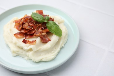 Photo of Fried bacon, mashed potato and basil on white table. Space for text