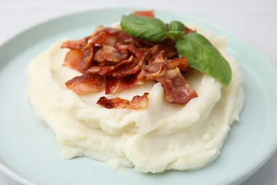 Fried bacon, mashed potato and basil on table, closeup