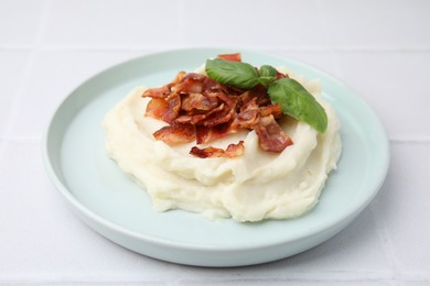 Photo of Fried bacon, mashed potato and basil on white table