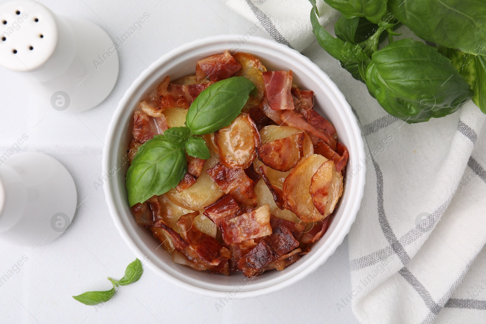 Photo of Delicious baked potatoes, bacon and basil on white table, top view