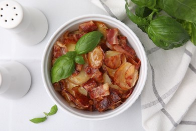 Photo of Delicious baked potatoes, bacon and basil on white table, top view