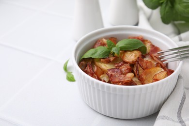 Photo of Delicious baked potatoes, bacon, basil and fork on white table, space for text