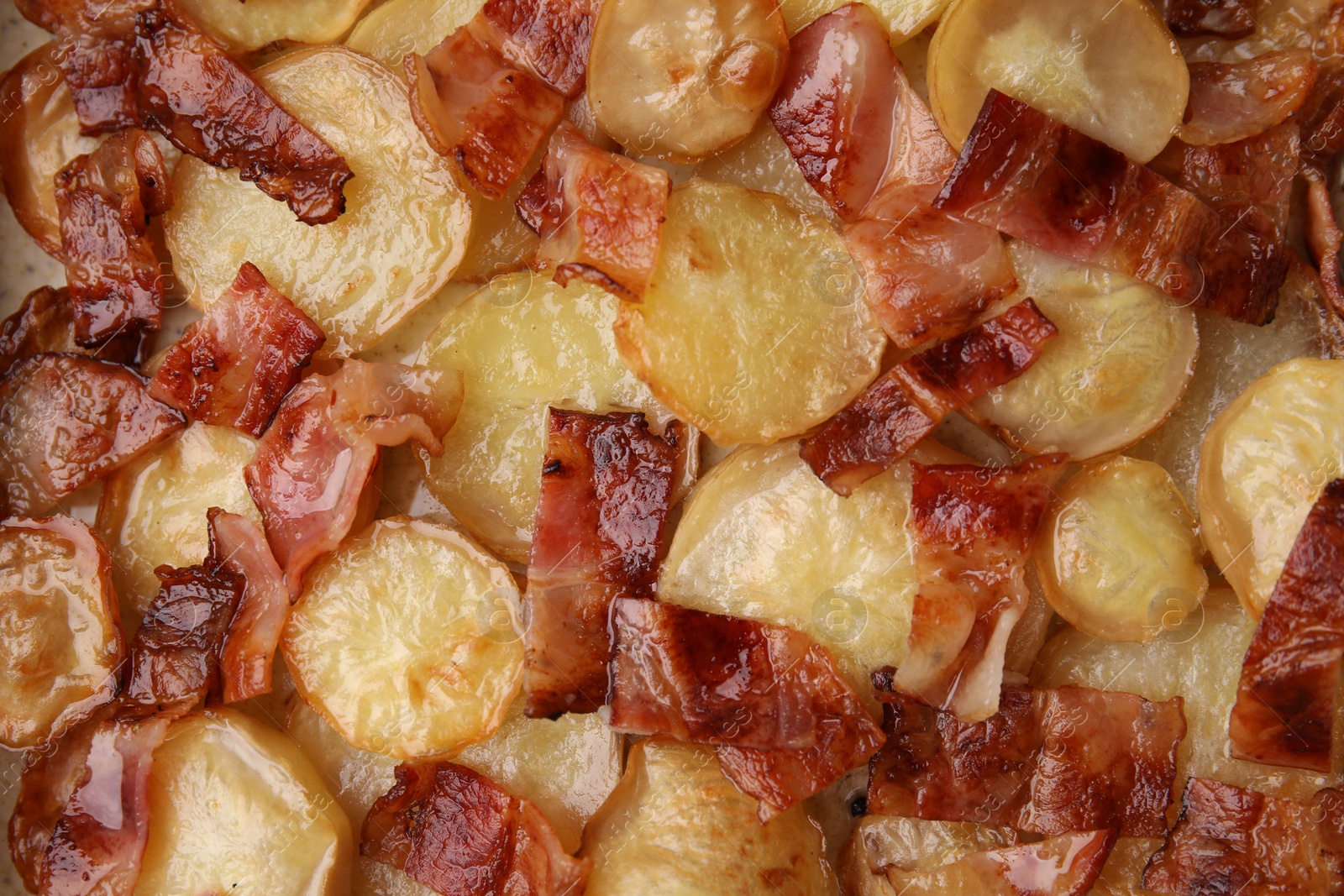 Photo of Delicious baked potatoes and bacon as background, top view