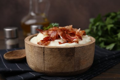 Photo of Fried bacon, mashed potato and parsley in bowl on table