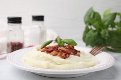 Photo of Fried bacon, mashed potato and basil on white table