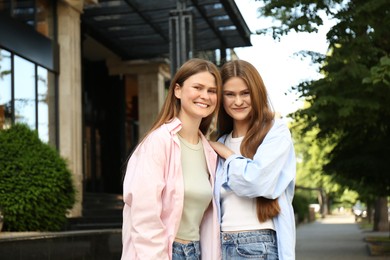 Portrait of two beautiful twin sisters outdoors