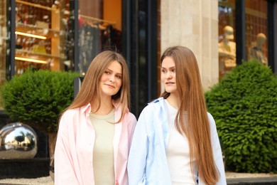 Portrait of two beautiful twin sisters outdoors