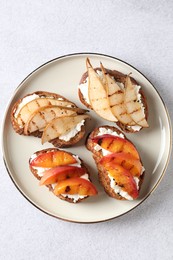 Photo of Delicious bruschettas with ricotta cheese on light grey table, top view