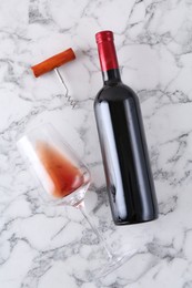 Corkscrew, bottle of wine and glass on white marble table, flat lay