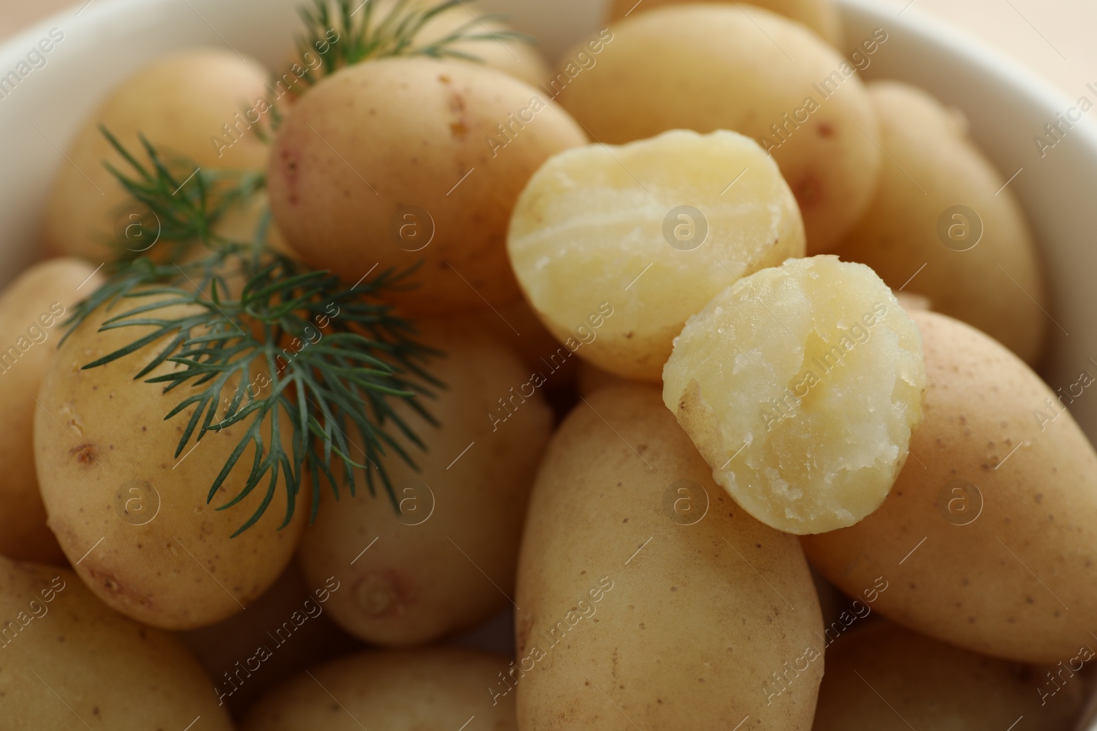 Photo of Boiled potatoes with dill in bowl, closeup